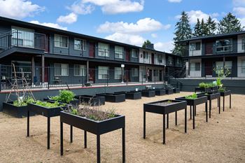 Community area with bbqs, picnic area, garden beds, bean bag toss, and boccie ball